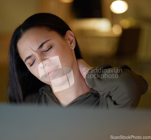 Image of Night, business and woman with neck pain, burnout and workaholic in modern office, stress and muscle tension. Dark, female employee or manager with strain, deadline or injury with joint and workplace