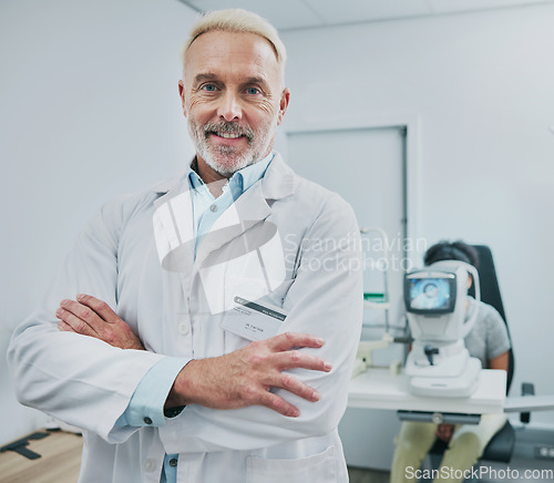 Image of Man, portrait and smile of optometrist with arms crossed in hospital or medical clinic for eye care. Healthcare, vision or happy, confident or proud senior male ophthalmologist or doctor of optometry