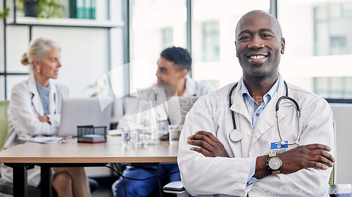 Image of Arms crossed, portrait and a doctor in healthcare meeting with vision, motivation and confidence. Happy, medicine and an expert African man in medical workshop, seminar or conference at a hospital