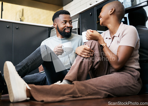 Image of Relax, talking and an African couple with coffee on the kitchen floor in the morning. Love, happy and black man and woman drinking a cup of tea, latte or warm beverage with conversation together