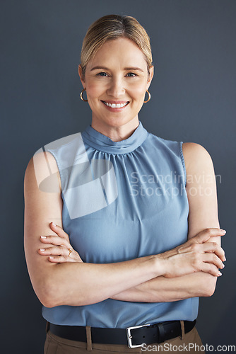 Image of Portrait, smile and business woman with arms crossed in studio isolated on a blue background. Ceo, boss and happy, confident and proud female entrepreneur from Canada with vision and success mindset.