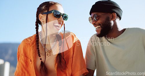 Image of Friendship, flirting and couple with sunglasses in city sitting on building rooftop laughing. Love, friends and romance, urban dating and freedom for gen z woman and man with smile on crazy fun date.