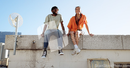 Image of Rooftop, relax and friends for social conversation together in cool wind, sunshine and blue sky mock up space for advertising gen z youth aesthetic. Happy black people couple on urban city building