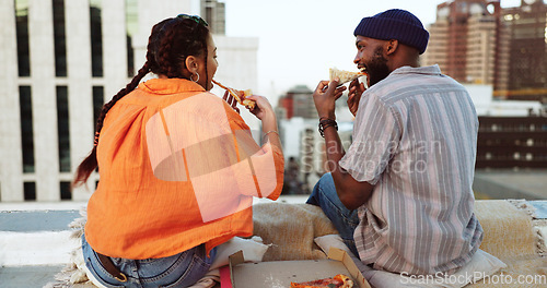 Image of Couple, eating and pizza date on city building rooftop in New York for bonding, trust or love support. Smile, happy or talking woman and black man with fast food in relax tourist location for summer