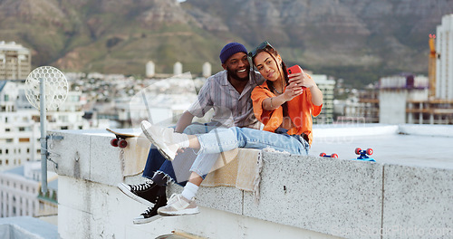 Image of Selfie, rooftop and couple with skateboard and smartphone for social media post, social network update or gen z lifestyle blog with urban cityscape. Influencer black people friends in phone portrait