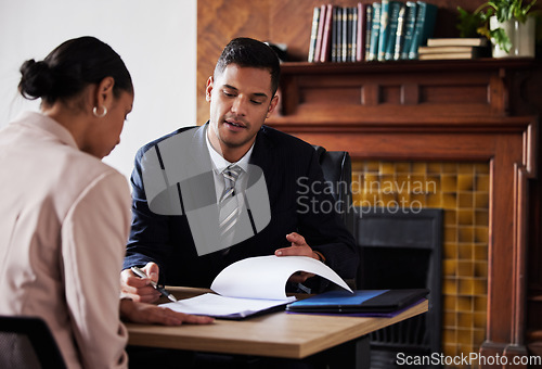 Image of Contract, signing and lawyer consulting a client in his office with legal paperwork or agreement. Signature, approval and businessman in discussion with a woman with a document to sign in workplace.