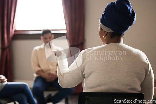 Image of Support, black woman and group of people in therapy with understanding, sharing feelings and talking in session. Mental health, addiction or depression, men and women with therapist sitting together.