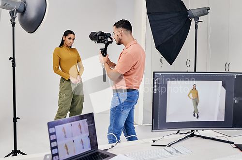 Image of Photography, shooting and photographer with woman fashion model in studio for creative, advertising and image. Media, backstage and profession man videographer with girl and equipment for photoshoot