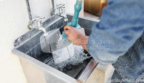 Image of Plumber, water and man with plunger for kitchen sink, maintenance and repairs, blockage or cleaning. Plumbing, drain and professional handyman fixing, clear and working with equipment for system fix