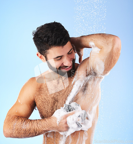 Image of Skincare, man and foam with water, cleaning and showering for wellness and hygiene against blue studio background. Male, gentleman and washing for morning routine, daily and dermatology on backdrop