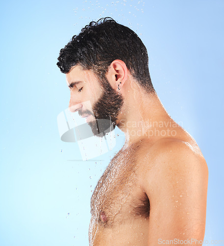 Image of Man, shower and profile of a model in water for cleaning, skincare and hygiene wellness. Isolated, blue background and studio with a young person in bathroom for dermatology and self care routine