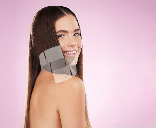 Image of Woman, hair beauty and studio portrait with smile, wellness and cosmetics with natural skin glow by pink background. Young gen z model, makeup and cosmetic self care for shine on healthy strong locks