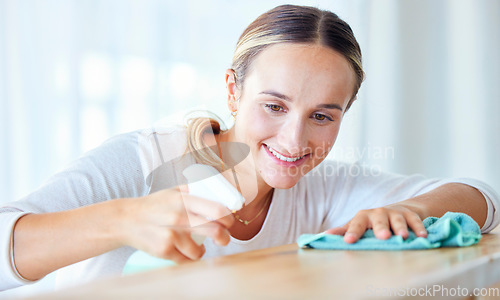 Image of Cleaning, spray bottle and disinfectant with a woman housekeeper in a home for hygiene or sanitizing. Wood, product and bacteria with a female cleaner in a house for housekeeping or domestic chores