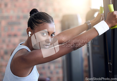 Image of Fitness, exercise and portrait of a woman with music at gym for health and wellness with training workout. Indian athlete person listening to earphones for motivation and inspiration to train body