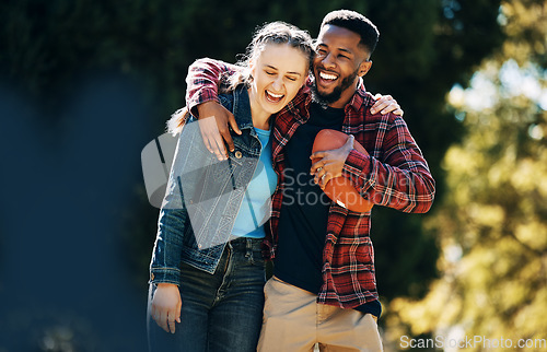 Image of Love, diversity couple and laughing in nature, having fun and playing football outdoors. Comic, interracial romance and happy black man and woman hug, laugh at funny joke and enjoying time together.