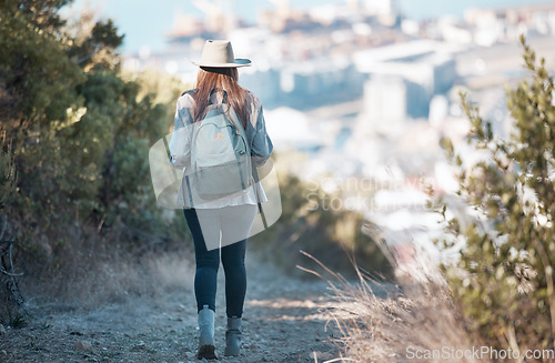 Image of Woman hiking, travel and trekking in nature park, adventure and fitness outdoor with backpack and exercise. Female hiker on trail, back view and walking with healthy active lifestyle and fresh air