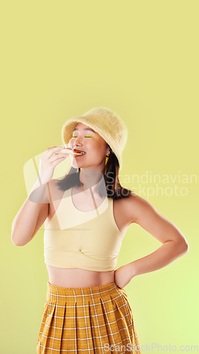 Image of Pizza, lunch and eating woman with food while isolated on a yellow background in a studio. Hungry, dinner and Asian girl enjoying a snack, take away or unhealthy meal with mockup on a backdrop