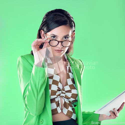 Image of Fashion, teacher and portrait of a woman in studio with glasses and paperwork to read. Style, trendy and female educator or model with stylish, cool and edgy outfit and spectacles by green background