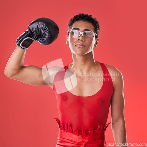Image of Portrait, boxing and gay man with gloves for a fight isolated on a red background in a studio. Strong, fitness and lgbt person showing muscle from self defense exercise, training and challenge