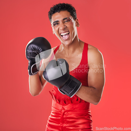 Image of Boxing, gloves and portrait of a gay man excited for a fight isolated on a red background in studio. Fitness, happy and lgbt person ready for a fighting competition, game and sport on a backdrop