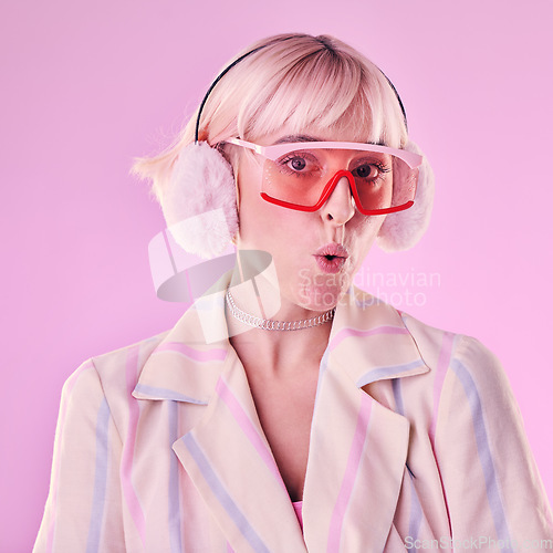 Image of Portrait, fashion and woman with unique style, trendy and pouting lips in studio background. Face, female and girl with glasses, funky and young person with casual, edgy and fu outfit on backdrop