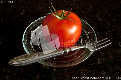 Image of Fresh tomato on the glass plate.