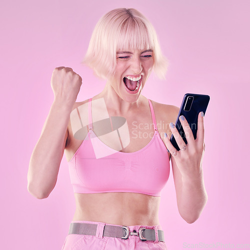 Image of Winner, fashion and woman with phone on pink background for success, winning and online competition. Smartphone, beauty and excited, happy and girl cheering for bonus, discount deal and promotion