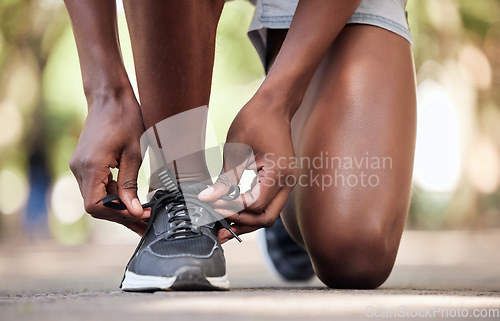 Image of Hands, fitness and tie shoes at park to start running, training or workout outdoors. Sports, wellness and black man or male athlete tying sneakers to get ready for exercise, jog or cardio for health.