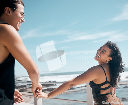 Image of Couple of friends, laughing or holding hands by beach, ocean or sea in romance mock up, trust or summer holiday fun. Smile, happy man or bonding woman in travel location, funny game or freedom play