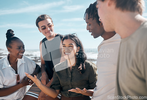Image of Woman, talking and bonding people by beach, ocean or sea in group social gathering, holiday community or summer storytelling. Smile, happy and diversity friends in travel location, relax or freedom