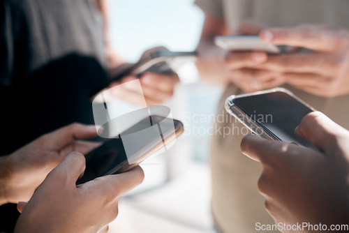 Image of Hands, phone and people networking on social media, mobile app or chatting on mockup screen. Hand of group holding smartphone in circle for online network share, data sync or communication on display