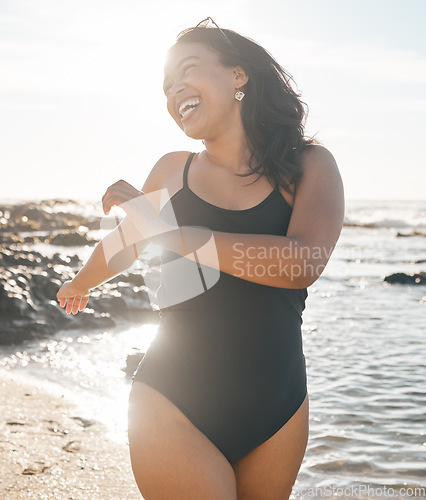 Image of Swimsuit woman, laughing and playing by beach, ocean or sea water in summer holiday, relax vacation or travel in body confidence. Smile, happy and fun student in swimwear for normal figure or shape