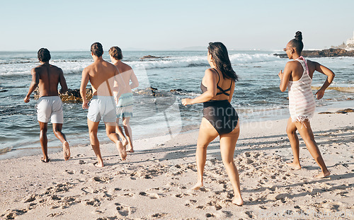 Image of Bonding friends, swimwear or running to sea, ocean or beach water on summer holiday, fun vacation or relax travel break. Men, women or diversity people in swimsuit for diversity freedom or swimming