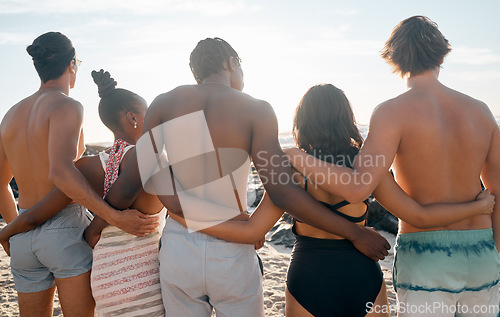 Image of Friends, back or standing embrace by beach, ocean or sea in social gathering, group vacation or relax summer holiday. Men, women or diversity people in hug, travel bonding or nature community support
