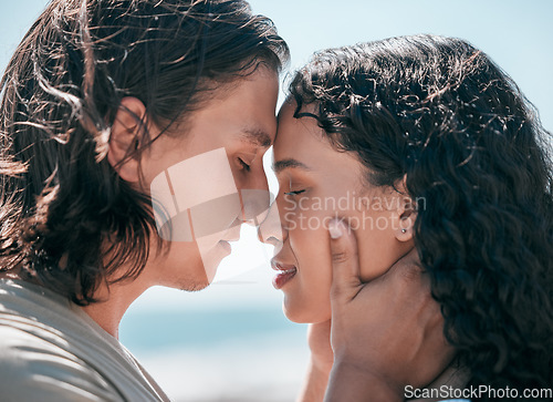 Image of Face, love and summer with a couple together at the beach, sharing an intimate moment outdoor closeup. Trust, travel or relax with a young man and woman enjoying a romantic date bonding in nature