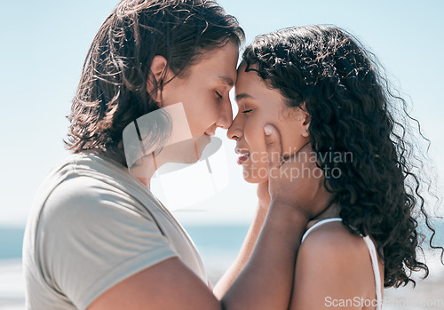 Image of Love, hands on face and couple relax at a beach, in love and romantic on blue sky background. Intimate, moment and romance by man with woman on ocean trip, sweet and calm relationship moment in Bali