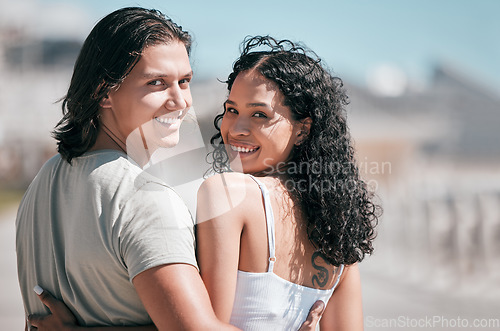 Image of Portrait, hug and couple at the beach for travel, fun and walking against blurred background. Face, love and woman embracing man rear view on vacation, relax and bond on a trip together in Miami