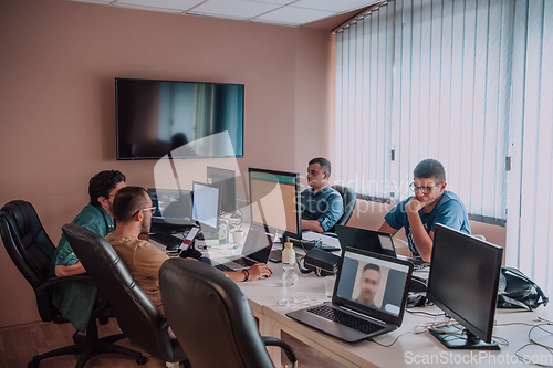 Image of Programmers engrossed in deep collaboration, diligently working together to solve complex problems and develop innovative mobile applications with seamless functionality.