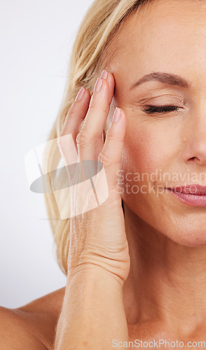 Image of Closeup, skincare and woman with cosmetics, dermatology and morning routine against studio background. Zoom mature female and lady with grooming, luxury salon treatment and smooth skin on backdrop