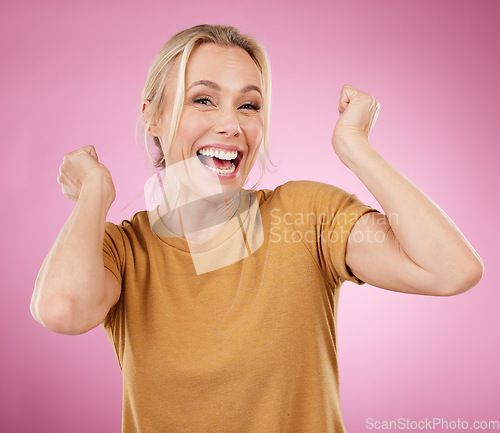 Image of Excited, winner and winning mature woman cheering for a prize isolated against a pink studio background happy and smile. Portrait, celebration and older female celebrate win feeling cheerful