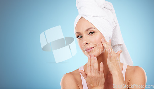 Image of Towel, portrait and woman touch face in studio for beauty, dermatology or mockup blue background. Female model, skincare shower and facial aesthetic for healthy shine, glow transformation or cleaning