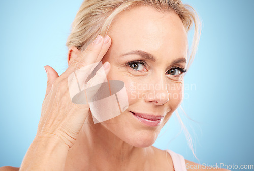 Image of Facial beauty, face and woman touch skincare on mockup, blue background and wellness cosmetics. Studio model, portrait and healthy aesthetic of laser dermatology, natural shine or botox salon results