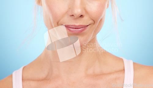 Image of Woman, beauty and skincare with lips, mouth and aesthetic botox cosmetics on blue background. Closeup female model, lip filler and face for plastic surgery, facial wellness and dermatology in studio