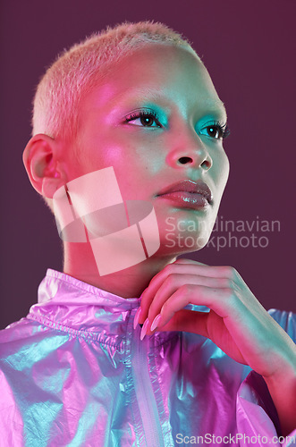 Image of Beauty, cyberpunk and high fashion woman with unique style, makeup and hairstyle isolated in a studio neon background. Futuristic, artistic and bright and colorful female is trendy and stylish
