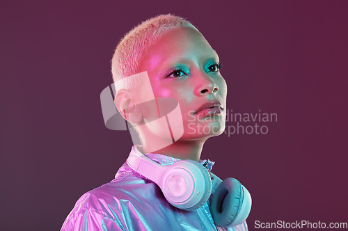 Image of Cyberpunk fashion, black woman and headphones in studio, holographic clothes and vaporwave style. Futuristic model, young gen z and listening to music with retro aesthetic, audio technology and neon