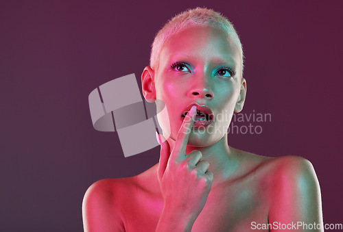Image of Neon, beauty and woman with finger on lips, makeup and lights for creative advertising on studio background. Cyberpunk, product placement and model isolated for skincare and futuristic mock up space.