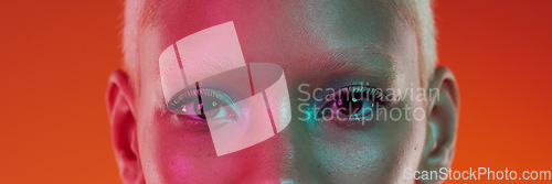 Image of Makeup, cyberpunk and portrait of the eyes of a woman isolated on an orange background in a studio. Edgy, creative and banner of the face of a trendy model with cosmetics, glamour and eyeshadow
