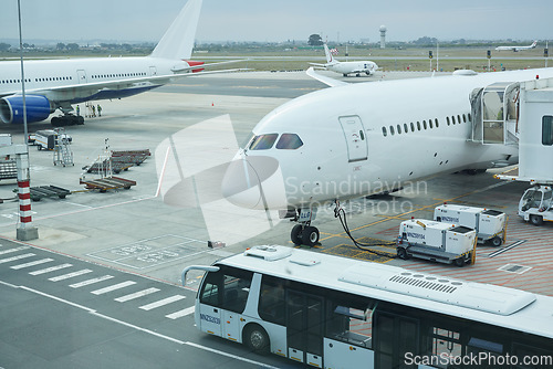 Image of Airplane, bus and loading luggage outdoors for travel with heat pump for air conditioning for ac ventilation on journey. Global, transportation or commercial aeroplane on ground with cargo for flight