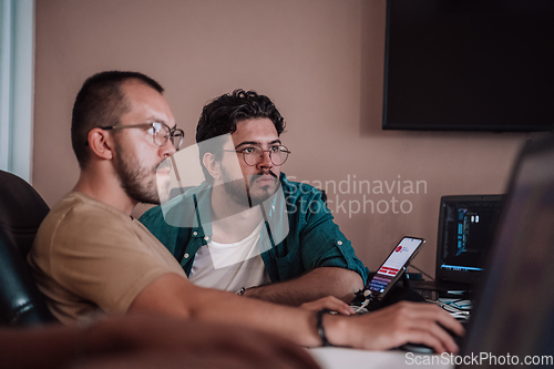 Image of Programmers engrossed in deep collaboration, diligently working together to solve complex problems and develop innovative mobile applications with seamless functionality.