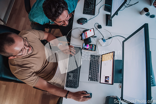 Image of Programmers engrossed in deep collaboration, diligently working together to solve complex problems and develop innovative mobile applications with seamless functionality.